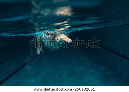 Male swimmer at the swimming pool.Underwater photo. Royalty-Free Stock Photo #250102051
