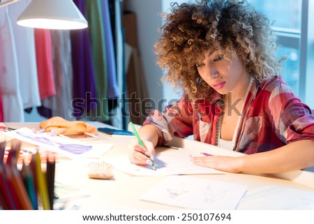 Young fashion designer working on new design