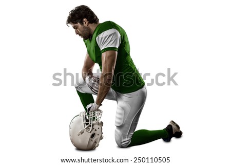 Football Player with a Green uniform on his knees, on a white background.