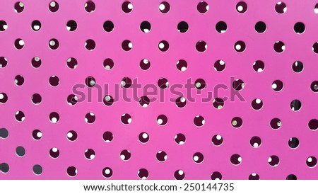 Pink sheet metal with holes background