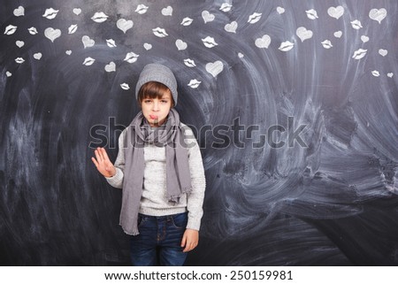 Little boy on a gray background unhappy