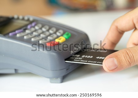Hand Push Credit Card Into A Credit Card Machine : Selective Focus Royalty-Free Stock Photo #250169596
