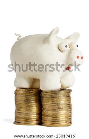 plasticine piggy bank stands on heaps of gold coins