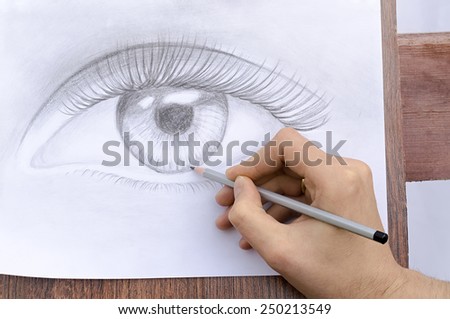 artist draws an eye a pencil