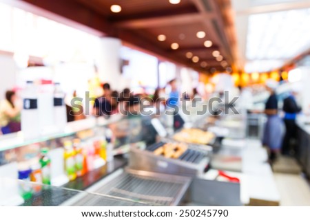 Close up abstract blurred people in food center