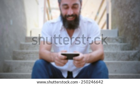 Happy bearded man in video call. Intentionally blurred editing post production background.
