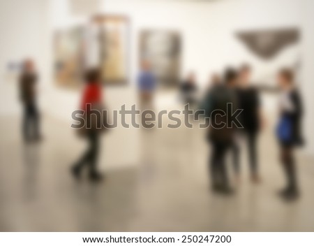 People visit an art gallery, generic background. Intentionally blurred editing post production background.