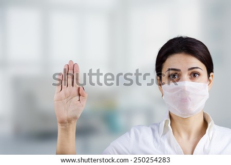 Female doctor with protective mask showing stop sign with her hand.Hospital,Prevention,Stop,Medical,Hospital,Danger