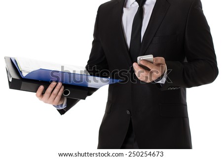 Businessman with files and mobile phone