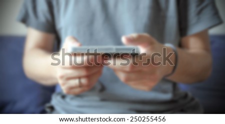 Man with his smart phone. Intentionally blurred editing post production.