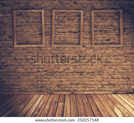 old grunge interior with blank frames against wall, retro filtered, instagram style