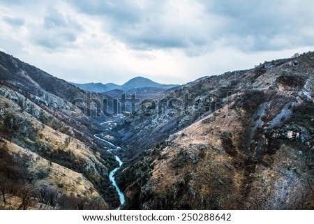 The canyon of Tara river (Kanjon rijeke Tare) in Montenegro, the Balkans - the second largest canyon in the world a?? on a cloudy winter day. View from the railway bridge Royalty-Free Stock Photo #250288642