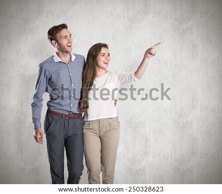 Full length of couple looking away against weathered surface