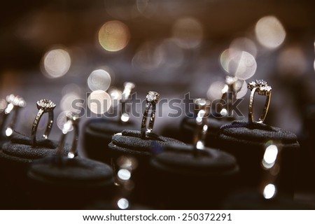 A lot of rings in jewelry window display Royalty-Free Stock Photo #250372291