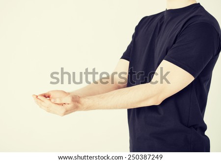 close up of mans hands showing something