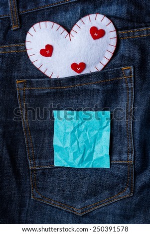 Heart on jeans background with crumpled paper for your text. valentines day card concept 