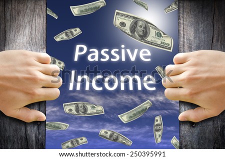 Passive Income and Financial Freedom Concept. Hand opening a wooden door and found a new world to success.