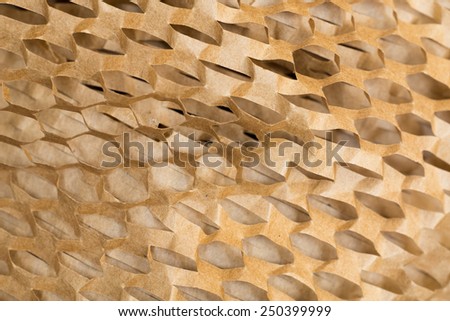 Closeup of brown paper packaging, cut to create a mesh