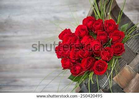 Beautiful bouquet of red roses in a basket