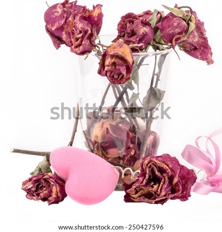 dried roses and pink heart isolated on white background
