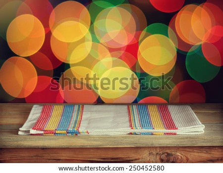 wooden table with a towel against a side