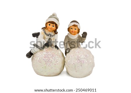 Gift figurine two children which mold snow balls isolated on a white background