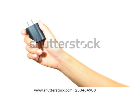 close up of hand holding black electrical plug isolated on white