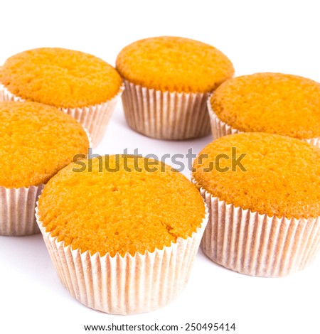 Tasty orange muffins on the white background
