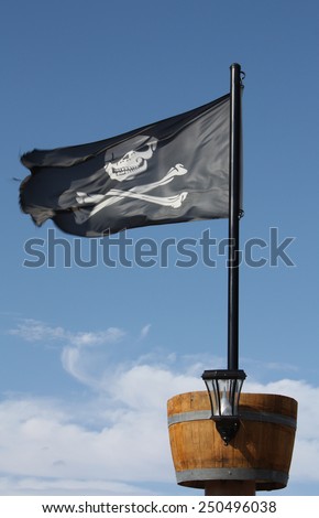 Pirate Flag Skull and Crossbones black pirate flag with crows nest. Royalty-Free Stock Photo #250496038