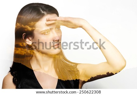 Double exposure of woman looking at horizon and sunset