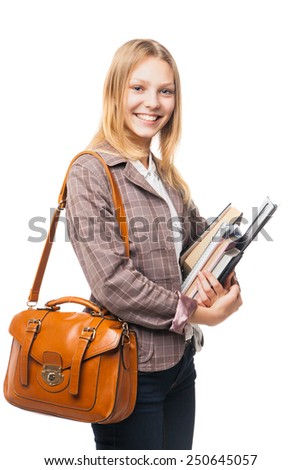 smiling young beautiful girl wearing jacket and jeans and standing sideways with brown bag and books   isolated on white