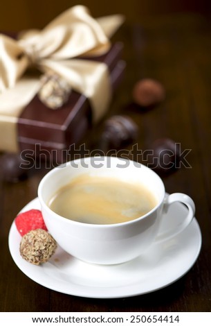 Coffee cup and saucer on a wooden table. Dark background