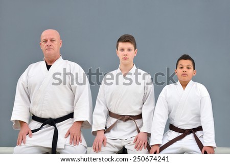 young, beautiful, successful multi ethical karate kids posing with karate master