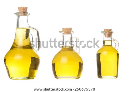 Extra virgin olive oil three glass jars with olive oil isolated on white background Royalty-Free Stock Photo #250675378