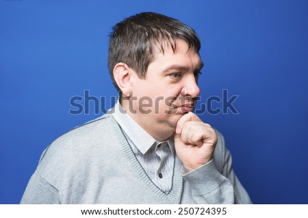 Closeup portrait of a man resting chin on hand