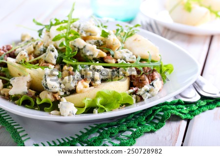 Pear, blue cheese and nut salad on plate Royalty-Free Stock Photo #250728982