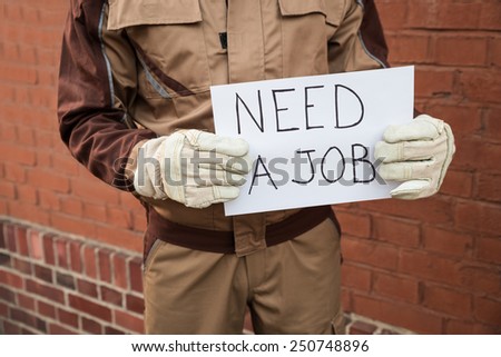 Close-up Of Worker Holding Placard With The Text Need A Job