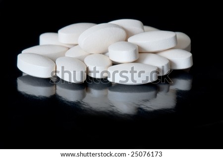 colored oblong pills on the isolated background