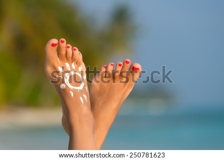 Beautiful female legs in the tropical beach conceptual image of vacation