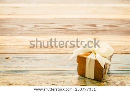 Gift box on wooden background - vintage effect style pictures