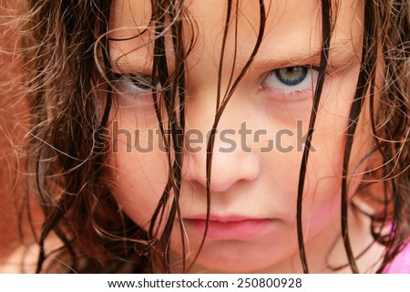  A very grumpy young girl with green eyes Royalty-Free Stock Photo #250800928
