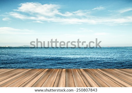 Wood, blue sea and sky background
