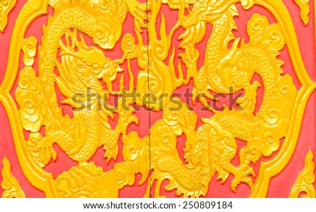 Gold dragon on red background in thailand.