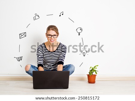 Portrait of young girl sitting on the floor with laptop surfing internet pages. Pretty smiling woman communicating via computer at home.  