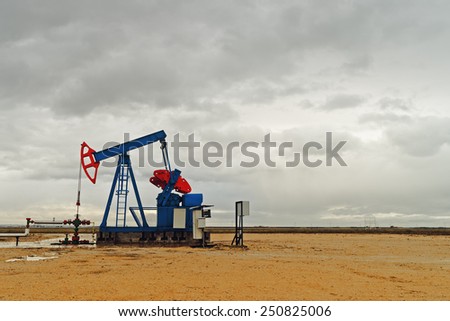 Pumpjack Oil Pump operating on natural gas in the field pumping from the oil well.