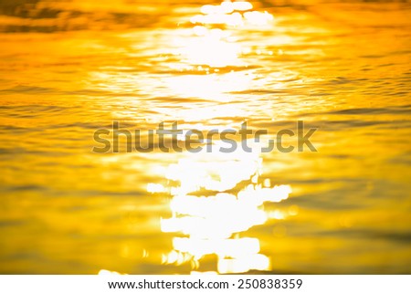 Blured surf sea  wave  at golden light sunset beach background defocused summer