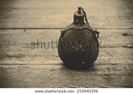 vintage old army bottle on the wood floor - retro color
