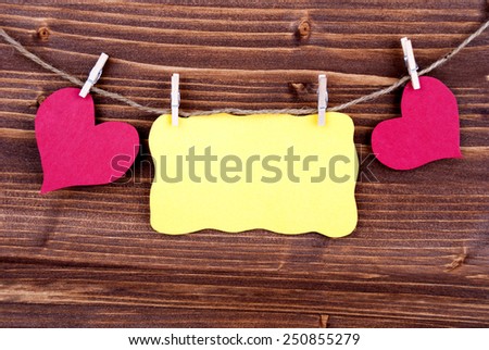 Yellow Tag Or Label With Two Hearts On A Line With Copy Space Or Your Free Text Here On Wooden Background, Two Symbols, Vintage, Retro And Old Fashion Style