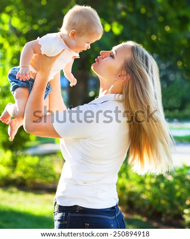 Portrait of a mother and her baby enjoy the summer sunset