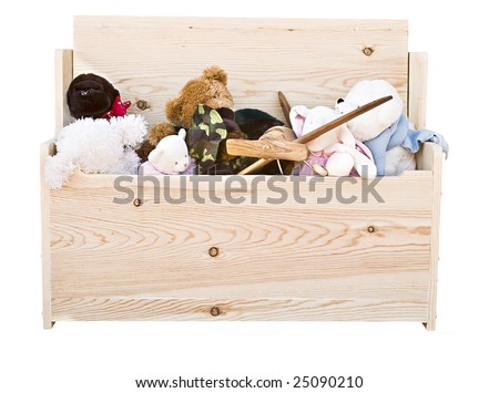 Various toys in a hand crafted toy box isolated on white background.